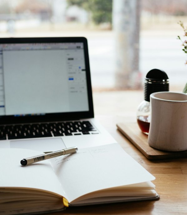 writing a blog, laptop and paper