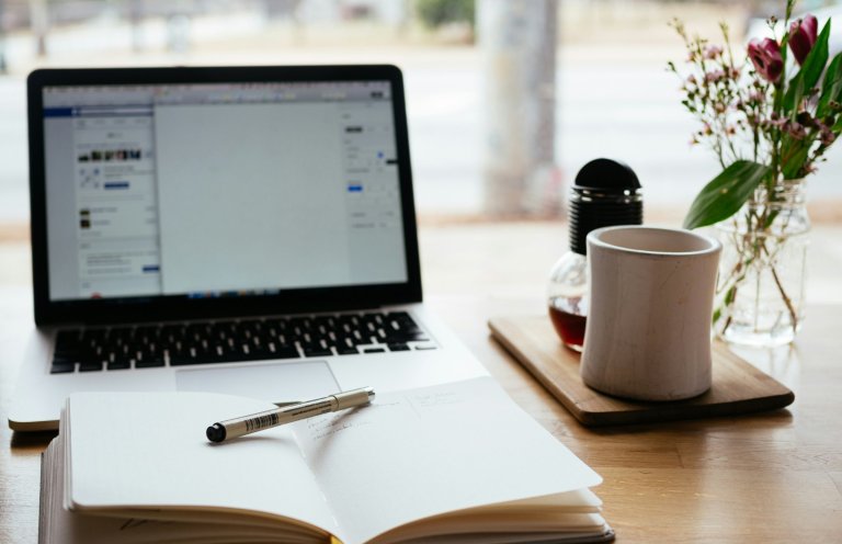 writing a blog, laptop and paper